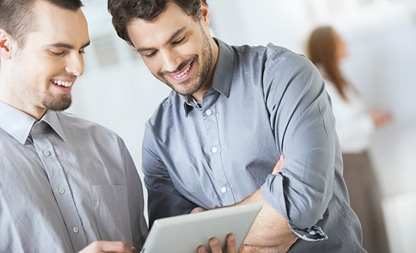 Two men looking at tablet